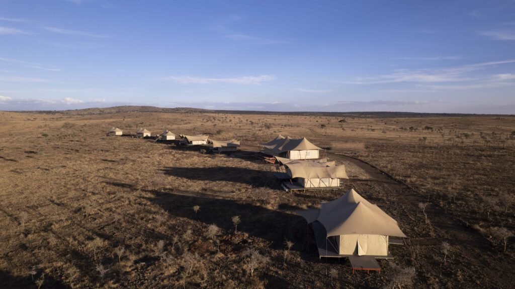 Aerial view of Escape Luxury Lodge tents at golden hour